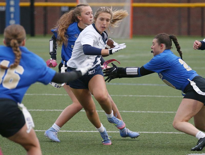 Thomas running back Olivia Smith picks up yards after the catch before being stopped by Schroeder’s Emma Rascoe and Jillian Pagano during their Section V flag football game Tuesday, May 5, 2026 at Webster Schroeder High School.