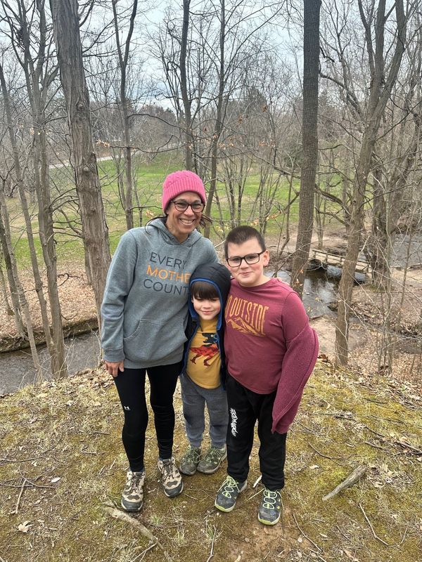 Reporter Victoria Freile and son Joe, 9, and Luke, 7, mid-hike in Webster Park in April 2026.