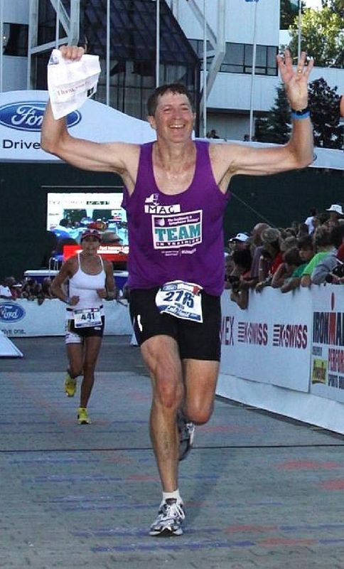 LaGrangeville's Mac Rand runs past the finish line of an Ironman event