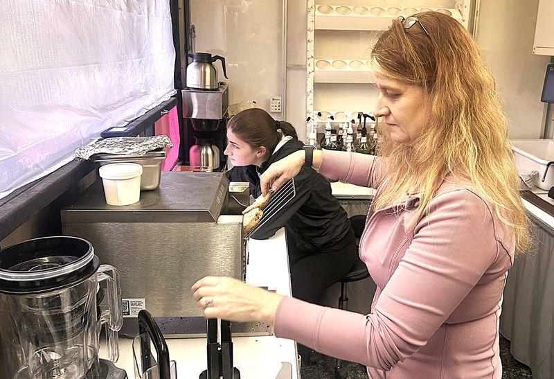 Lawana Morse, owner of Wholesome Wheels-Wholesome Cafe on state Route 14 in Pine Valley, just north of Horseheads, prepares a bagel while her daughter, Katrina Kraft, takes a customer order Friday, May 8, 2026. The drive-through cafe opened April 27, 2026.