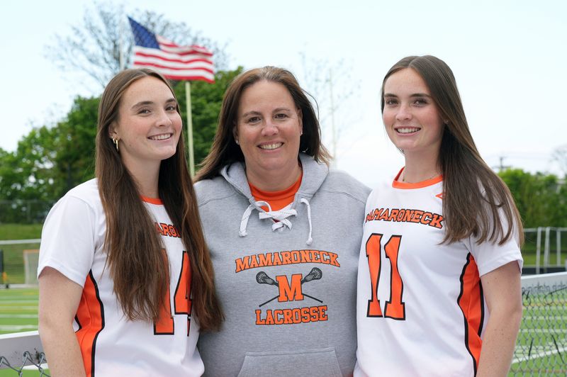 Bari Suman, the longtime Mamaroneck athletic director with her two daughters, Lindsey and Lexi prior to a lacrosse game at Mamaroneck High School May 8, 2026. Susan is retiring at the end of the school year.