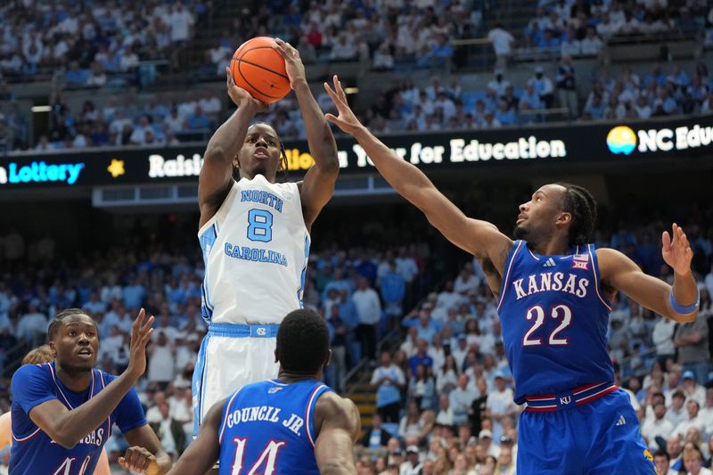 Nov 7, 2025; Chapel Hill, North Carolina, USA; North Carolina Tar Heels forward Caleb Wilson (8) shoots as Kansas Jayhawks forward Flory Bidunga (40) and guard Melvin Council Jr. (14) and guard Darryn Peterson (22) defend in the second half at Dean E. Smith Center. Mandatory Credit: Bob Donnan-Imagn Images