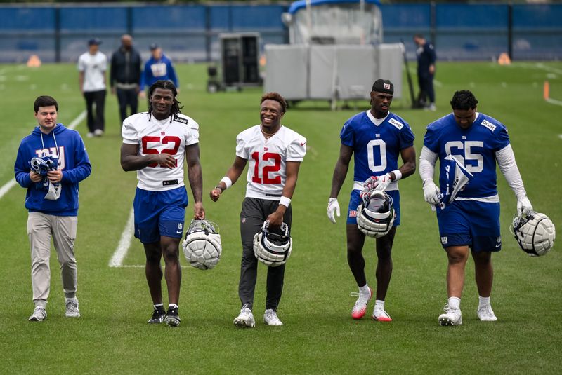 May 9, 2026; East Rutherford, NJ, USA; New York Giants rookies Arvell Reese (52), Colton Hood (12), Malachi Fields (0) and Francis Mauigoa (65) walk off the field after rookie minicamp at Quest Diagnostics Training Center. Mandatory Credit: John Jones-Imagn Images