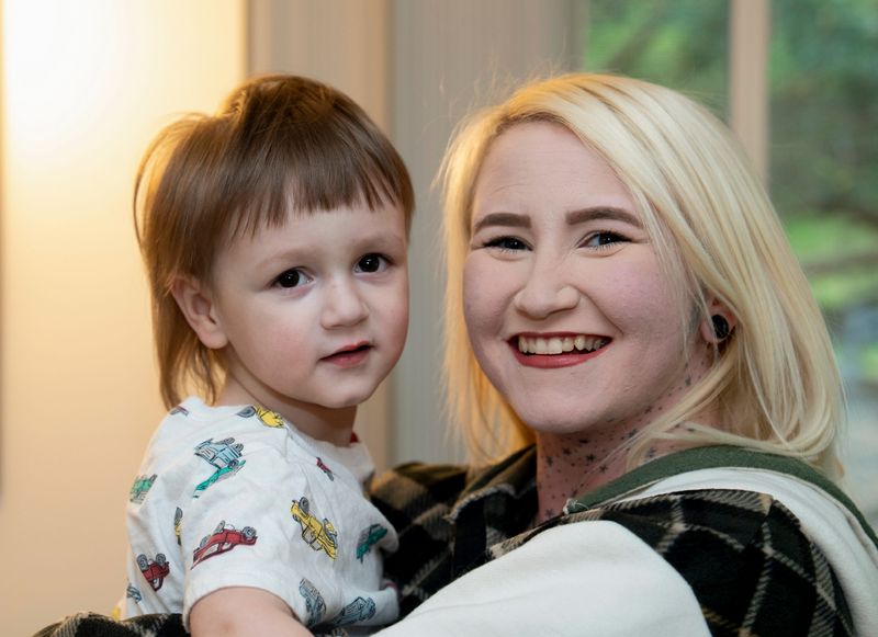Travis Smith, 2, and his mother Sierra, were photographed at their East Greenbush, New York home on Wednesday, May 13, 2026. Travis was born with OTOF Related Deafness, was part of a trial with a gene therapy procedure by Regeneron named Otarmeni, and has been slowly been gaining his hearing.