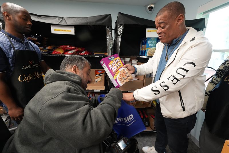 Direct Support ProfessionalÊRonald Roberty, right, helps Eric Perez, a participant in Jawonio day services, pack his bag at the newly launched food pantry that was created to help its Direct Support Professionals and individuals who receive services at Jawonio May 14, 2026 in New City.