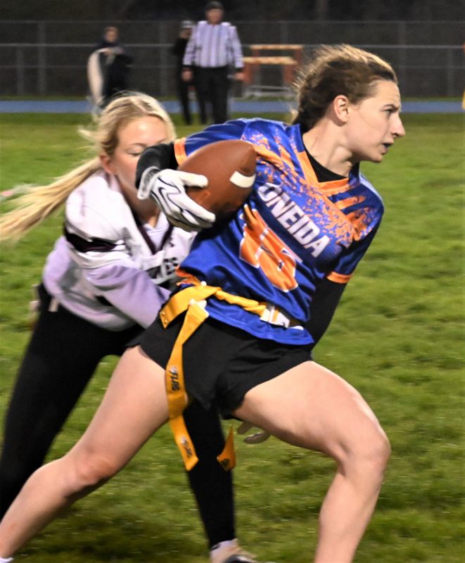 Oneida's Jane Albertina runs with the ball and tries to escape a Sherburne-Earlville tackler during an April 28 game played in Oneida.