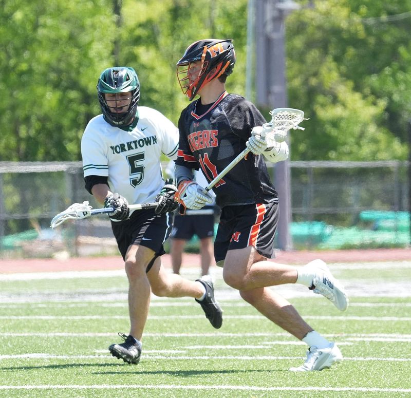 Mamaroneck's Owen Reese (11) works against Yorktown's Tyler Carlcati (5) during boys lacrosse action at Yorktown High School in Yorktown Heights on Saturday, May 16, 2026. Mamaroneck won 10-5.