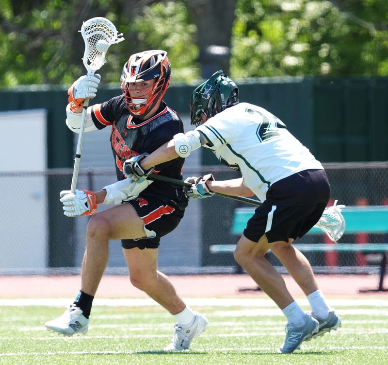 Mamaroneck's Jake Reese (22) works against Yorktown's Cooper Constantine (24) during boys lacrosse action at Yorktown High School in Yorktown Heights on Saturday, May 16, 2026. Mamaroneck won 10-5.