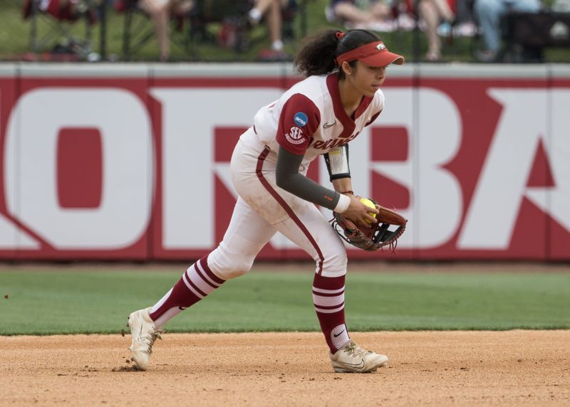 May 17, 2026; Fayetteville, AR, USA; Arkansas Razorbacks infielder Atalyia Rijo (26) fields the ball and throws to first for an out in the fifth inning against the South Florida Bulls during the NCAA Softball Fayetteville Regional at Bogle Park. Arkansas won 10-2. Mandatory Credit: Brett Rojo-Imagn Images