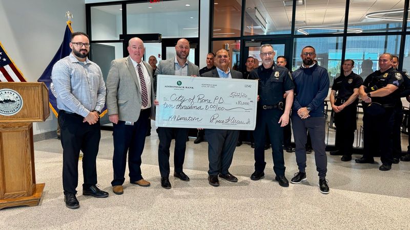 Adirondack Bank officials present a check to the city of Rome and Rome Police Department.