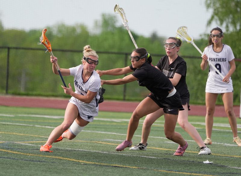 Pittsford’s Sydnie Borrell drives towards the net trying to get past Hilton’s Ava Tata who is pushing against her during their quarterfinal playoff game at Pittsford Sutherland High School in Pittsford on May 22, 2026.