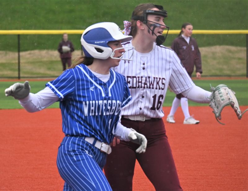 Whitesboro runner Sydney Strife and Central Square third baseman Alexandria Bell (right) watch a play at the plate Saturday during their Section III quarterfinal playoff.