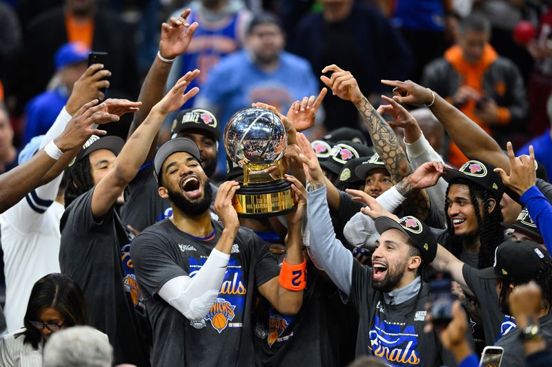 May 25, 2026; Cleveland, Ohio, USA; New York Knicks center Karl-Anthony Towns (32) lifts the 2026 Eastern Conference trophy with teammates after defeating the Cleveland Cavaliers in game four of the eastern conference finals for the 2026 NBA playoffs at Rocket Arena. Mandatory Credit: David Richard-Imagn Images