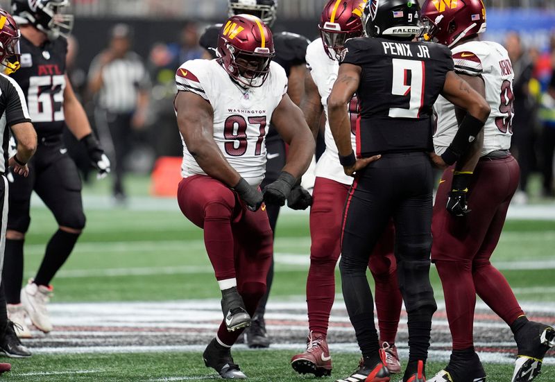 Sep 28, 2025; Atlanta, Georgia, USA; Washington Commanders nose tackle Eddie Goldman (97) celebrates after a play during the first half against the Atlanta Falcons at Mercedes-Benz Stadium. Mandatory Credit: Dale Zanine-Imagn Images