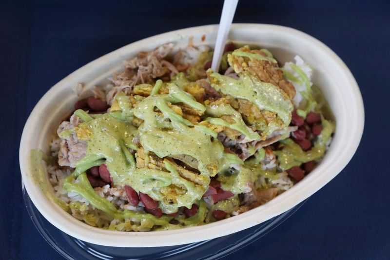 The Jibaro Plate, featuring rice & beans, roasted pork, sliced tostones, and Jibaro sauce topped with avocado, at Rob’s Kabobs at the first of the season Food Truck Rodeo held at the City of Rochester Public Market Wednesday, April 29, 2026.