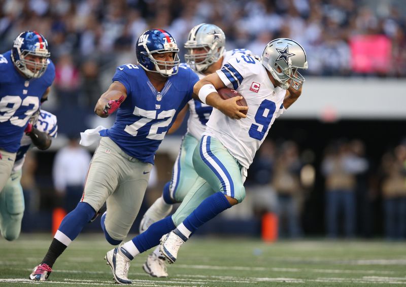 Oct 28, 2012; Arlington, TX, USA; New York Giants defensive end Osi Umenyiora (72) pressures Dallas Cowboys quarterback Tony Romo (9) at Cowboys Stadium. Mandatory Credit: Matthew Emmons-USA TODAY Sports