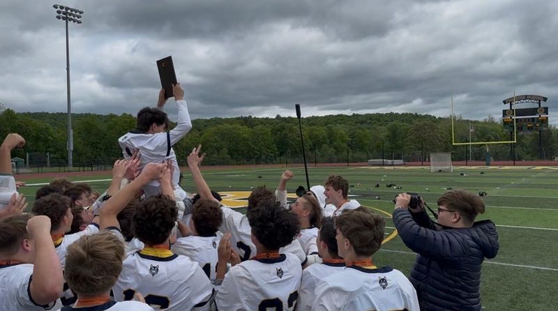 The Highland boys lacrosse team lifts up senior goaltender Justin Caballero after defeating Saugerties in the Section 9 Class C championship at FDR High School on May 30.