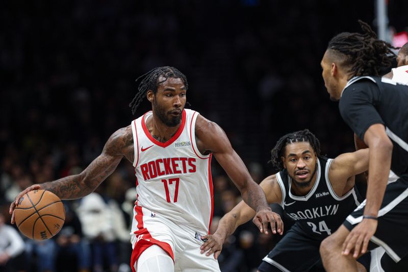 Jan 1, 2026; Brooklyn, New York, USA; Houston Rockets forward Tari Eason (17) dribbles as Brooklyn Nets guard Cam Thomas (24) defends during the second half at Barclays Center. Mandatory Credit: Vincent Carchietta-Imagn Images