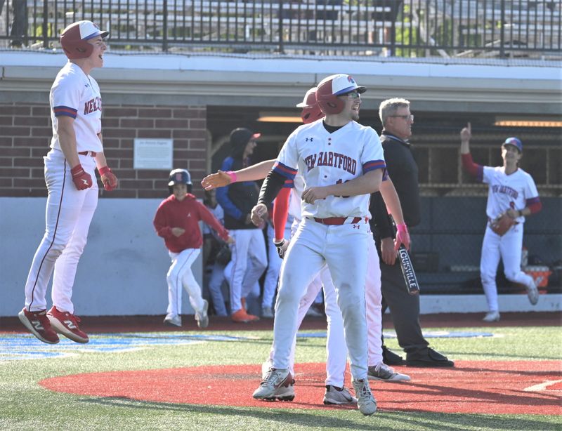 New Hartford teammates including Peyton Way (left) and Ashton Palmer celebrate at home plate Saturday after scoring on Spartan Johnny Vitullo's bases-loaded double against South Jefferson during a Section III playoff baseball game at Onondaga Community College.