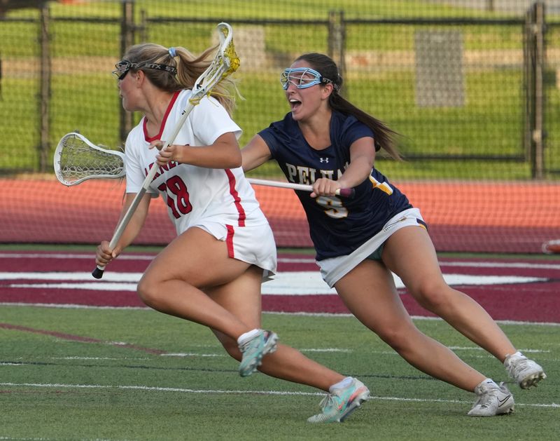 Rye's Mary Ebeling is pressured by Pelham's A ddison Matyko at the Class C girls lacrosse final played at Nyack June 2, 2026. Rye won 15-9.