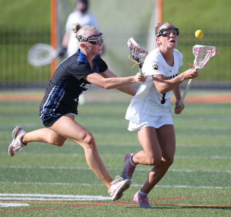 Honeoye Falls-Lima’s Harper Jacob chases down a loose ball a step ahead of Livonia/Avon/Geneseo’s Lily Rowe during their Class C girls lacrosse sectional final Tuesday, June 2, 2026 at Growney Stadium at St. John Fisher University.