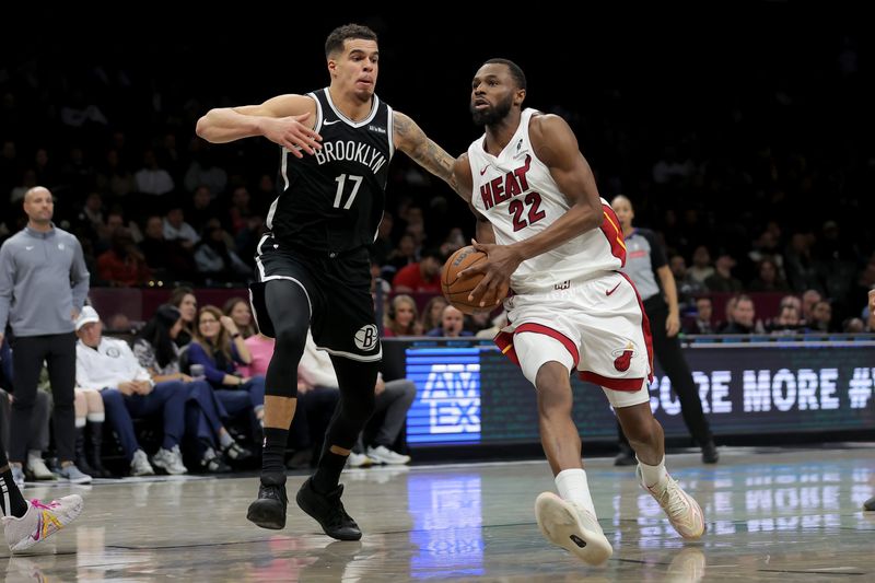 Dec 18, 2025; Brooklyn, New York, USA; Miami Heat forward Andrew Wiggins (22) drives to the basket against Brooklyn Nets forward Michael Porter Jr. (17) during the fourth quarter at Barclays Center. Mandatory Credit: Brad Penner-Imagn Images