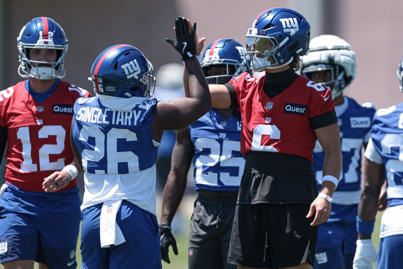 Jun 3, 2026; East Rutherford, NJ, USA; New York Giants quarterback Jaxson Dart (6) and running back Devin Singletary (26) slap hands during organized team activities at Quest Diagnostics Training Center. Mandatory Credit: Vincent Carchietta-Imagn Images