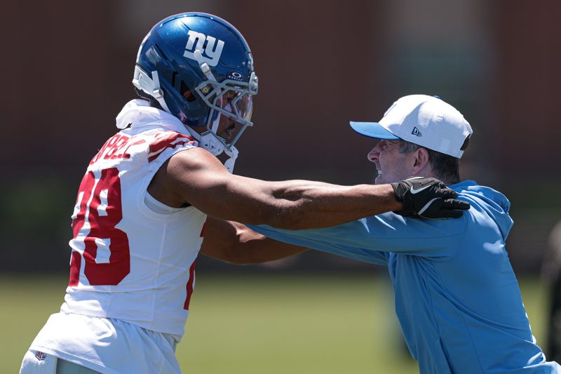 Jun 3, 2026; East Rutherford, NJ, USA; New York Giants defensive back Elijah Campbell (28) is instructed by head coach John Harbaugh during drills at an organized team activities at Quest Diagnostics Training Center. Mandatory Credit: Vincent Carchietta-Imagn Images