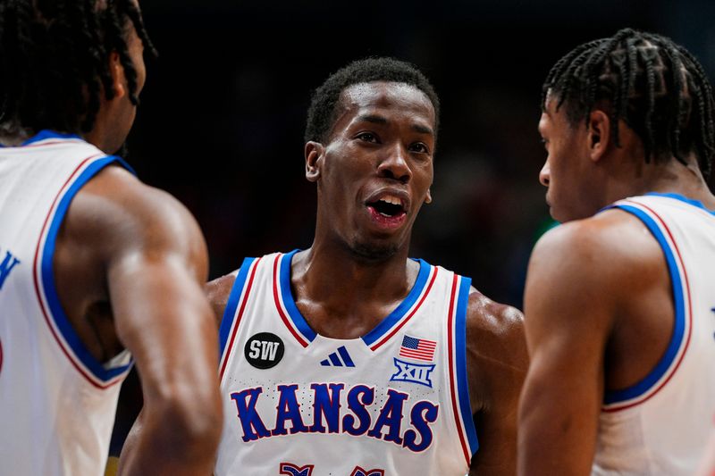 Jan 13, 2026; Lawrence, Kansas, USA; Kansas Jayhawks guard Melvin Council Jr. (14) talks with guard Darryn Peterson (22) and guard Elmarko Jackson (13) during the first half against the Iowa State Cyclones at Allen Fieldhouse. Mandatory Credit: Jay Biggerstaff-Imagn Images