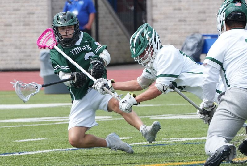 Yorktown’s Frankie Ofrias (2) gets hit as he gets off a shot that went for a first half goal against Cornwall during the boys state lacrosse Class B regional final High School June 6, 2026. Yorktown won the game 18-5.