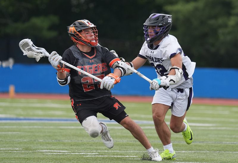Mamaroneck's Nate Kulish (27) works the ball during the NYSPHSAA boys lacrosse Class A regional final against Monroe-Woodbury at Middletown High School in Middletown on Saturday, June 6, 2026.