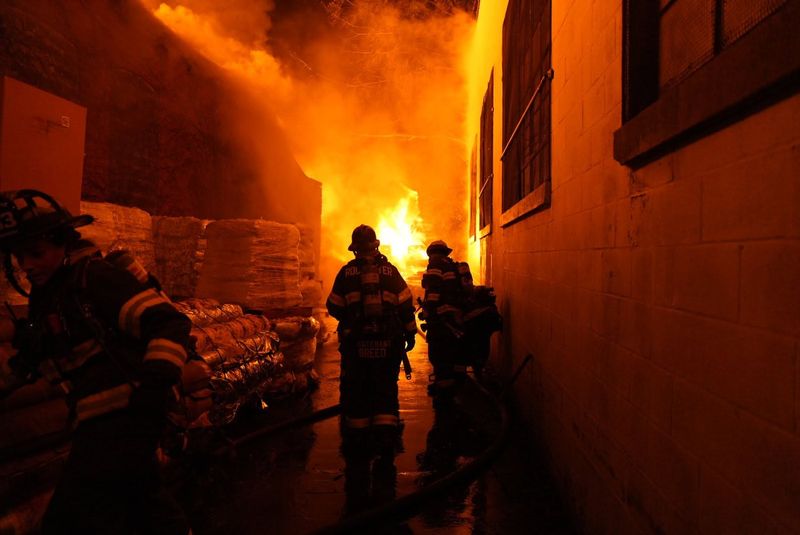 Firefighters battle a fire at Pallet Express on Lyell Avenue in Rochester on June 7, 2026.