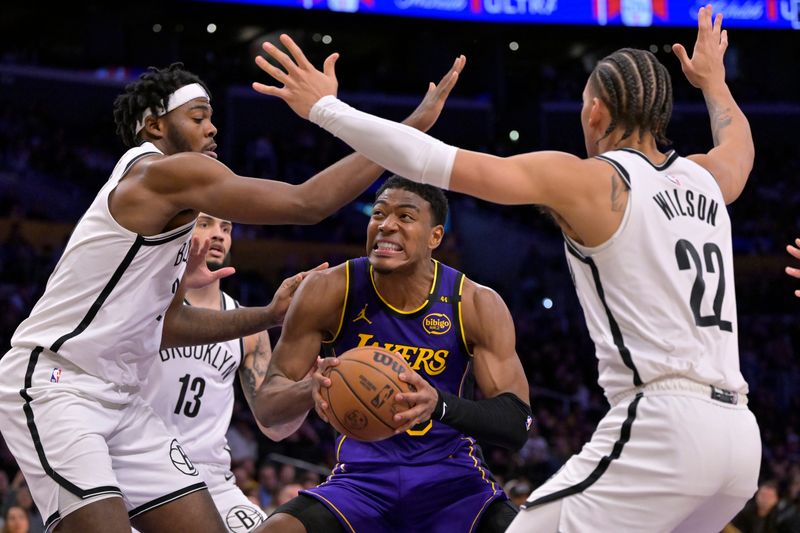 Jan 17, 2025; Los Angeles, California, USA; Brooklyn Nets center Day'Ron Sharpe (20) and forward Jalen Wilson (22) defend Los Angeles Lakers forward Rui Hachimura (28) in the second half at Crypto.com Arena. Mandatory Credit: Jayne Kamin-Oncea-Imagn Images