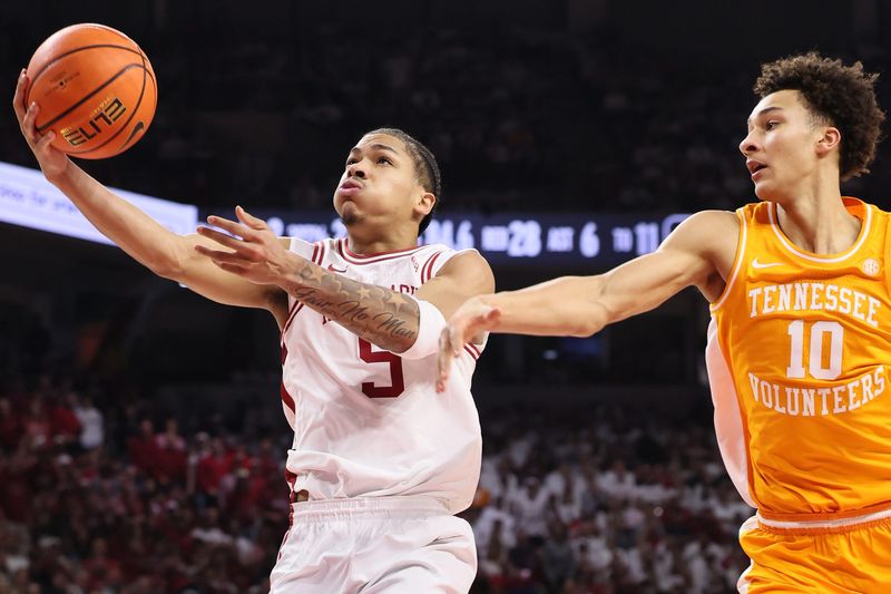 Jan 3, 2026; Fayetteville, Arkansas, USA; Arkansas Razorbacks guard Darius Acuff Jr (5) drives to the basket as Tennessee Volunteers forward Nate Ament (10) defends during the second half at Bud Walton Arena. Mandatory Credit: Nelson Chenault-Imagn Images