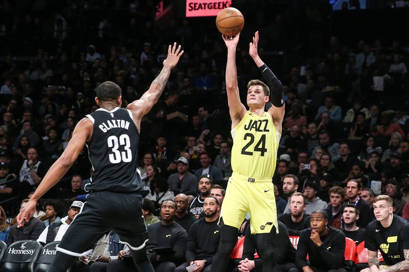 Apr 2, 2023; Brooklyn, New York, USA;  Utah Jazz center Walker Kessler (24) shoots over Brooklyn Nets center Nic Claxton (33) in the third quarter at Barclays Center. Mandatory Credit: Wendell Cruz-USA TODAY Sports