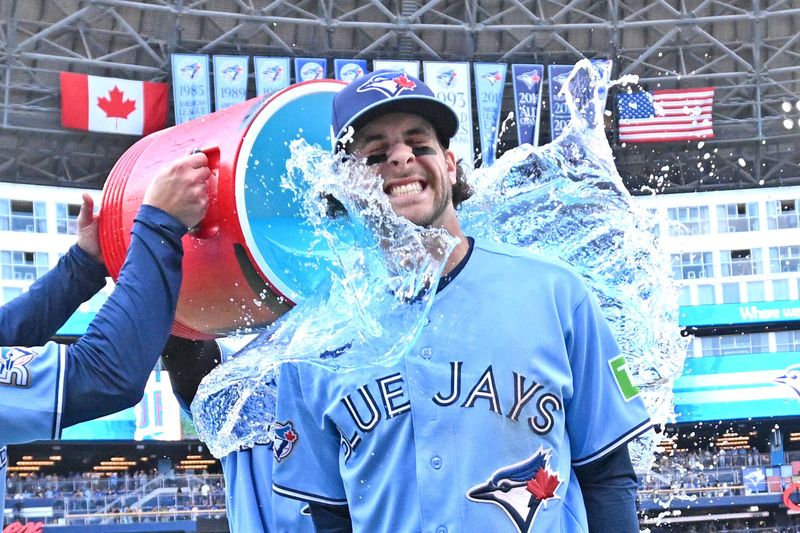 Jun 6, 2026; Toronto, Ontario, CAN; Toronto Blue Jays second baseman Ernie Clement (22) is doused with ice water as he celebrates a win over the Baltimore Orioles at Rogers Centre.