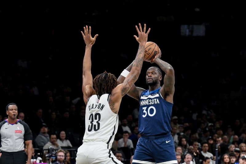 Nov 3, 2025; Brooklyn, New York, USA; Minnesota Timberwolves forward Julius Randle (30) looks to pass against Brooklyn Nets center Nic Claxton (33) during the first half at Barclays Center. Mandatory Credit: John Jones-Imagn Images