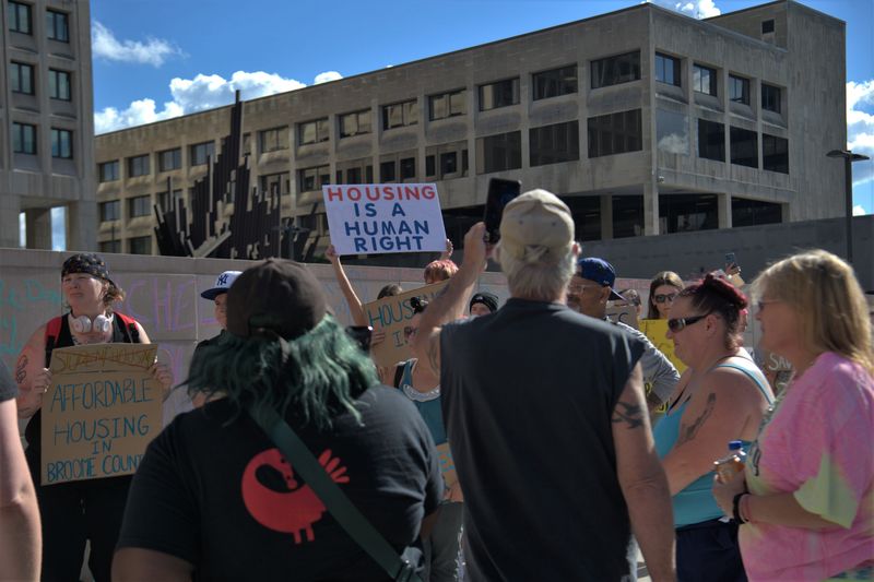 Demonstrators held signs along the sidewalk outside the Broome County Office Building on June 23, 2026 calling on the community and elected officials to do better for the residents of Broome County in response to the fatal Knights Inn fire.