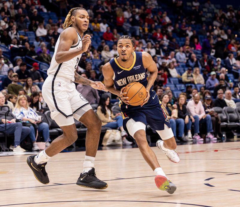 Jan 14, 2026; New Orleans, Louisiana, USA;  New Orleans Pelicans forward Trey Murphy III (25) dribbles against Brooklyn Nets forward/center Noah Clowney (21) during the second half at Smoothie King Center. Mandatory Credit: Stephen Lew-Imagn Images
