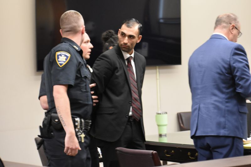 Aaron Alshaman is placed in handcuffs following his guilty verdict on June 25 in Oneida County Court after a jury of his peers found him guilty of arson and four counts of attempted murder. Casey Pritchard