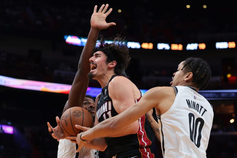 Mar 3, 2026; Miami, Florida, USA; Miami Heat forward Jaime Jaquez Jr. (11) drives to the basket against Brooklyn Nets forward Josh Minott (00) and center Day'ron Sharpe (20) during the third quarter at Kaseya Center. Mandatory Credit: Sam Navarro-Imagn Images