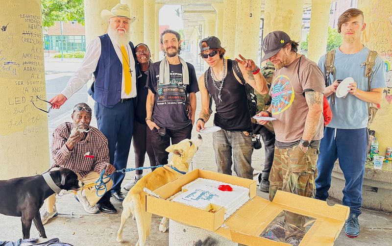 Artist and activist Julian Raven, second from left, is joined by some of his supporters after formally announcing he is running for mayor of Elmira.