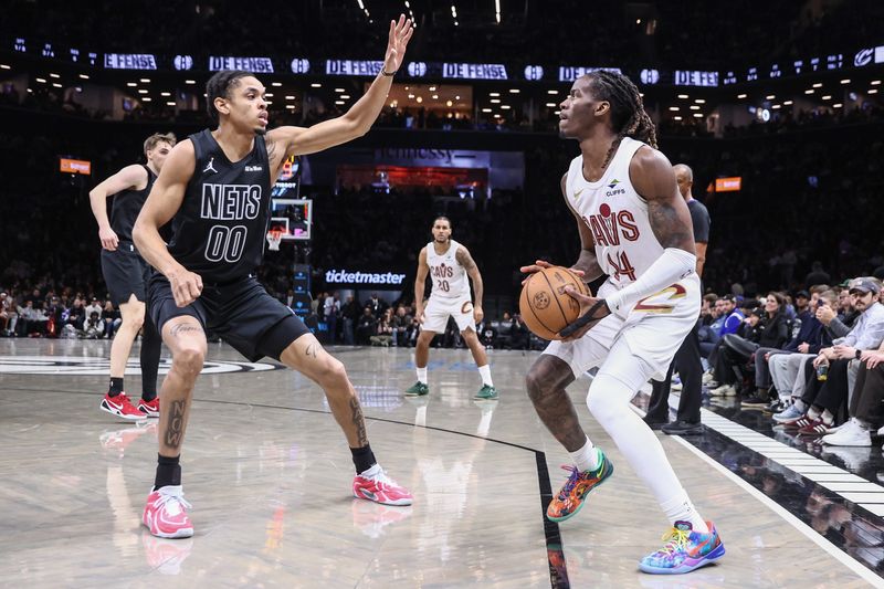 Mar 1, 2026; Brooklyn, New York, USA; Cleveland Cavaliers guard Keon Ellis (14) looks to shoot past Brooklyn Nets forward Josh Minott (00) in the first quarter at Barclays Center. Mandatory Credit: Wendell Cruz-Imagn Images