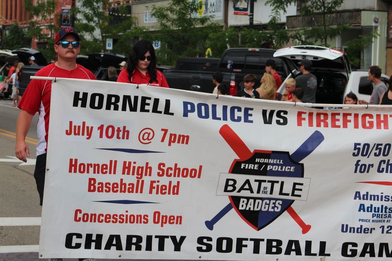 Hornell police and firefighters marched in the July 4 parade to highlight the upcoming charity softball game happening July 10 at Maple City Park.