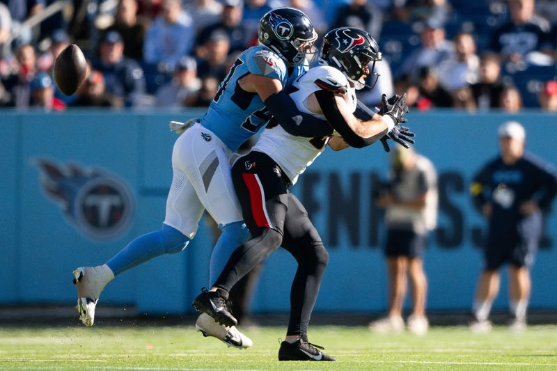 Nov 16, 2025; Nashville, Tennessee, USA;  Tennessee Titans defensive lineman C.J. Ravenell (91) breaks up a pass thrown to Houston Texans tight end Dalton Schultz (86) during the first half at Nissan Stadium. Mandatory Credit: Steve Roberts-Imagn Images