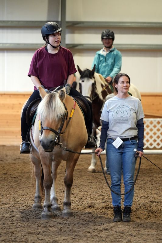 Julia Browne, 14, and Will Black, 25, participate in a therapy riding session at Endeavor Therapeutic Horsemanship July 7, 2026 in Mount Kisco. The non-profit organization uses calming and healing interaction with horses to uplift children with developmental disabilities, veterans with PTSD, local prison inmates and others who participate in Endeavor's programs.