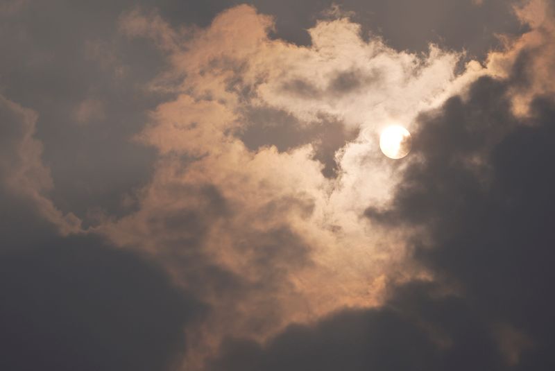 Smoke from wildfires in Canada have made their way into the Rochester area July 15, 2026.  As clouds and smoke cover the sun a red haze can been seen around the sun.