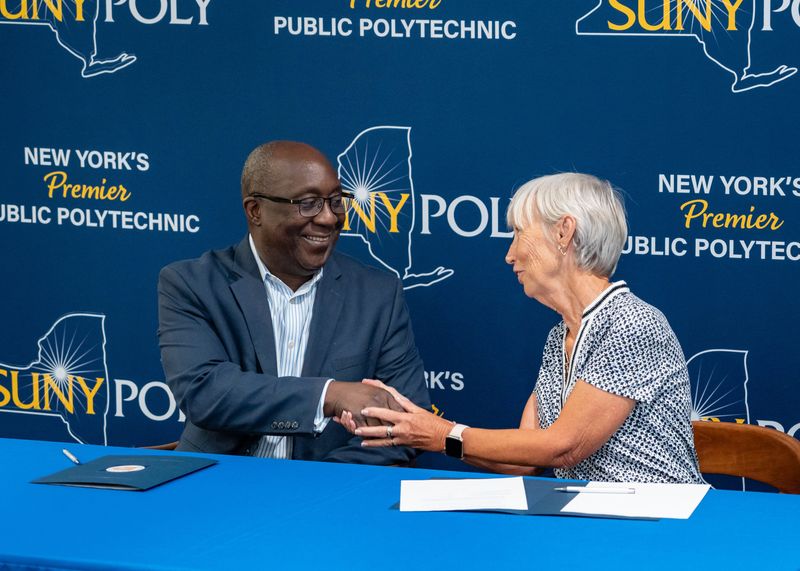 SUNY Poly 
President Winston Soboyejo and President Kathleen Bagley Santarcangelo of the Julia O. Wells Memorial Education Foundation make the scholarship endowment official while inside the Cayan Library at SUNY Polytechnic Institute on Wednesday, July 15, 2026. Daniel DeLoach/Utica Observer-Dispatch