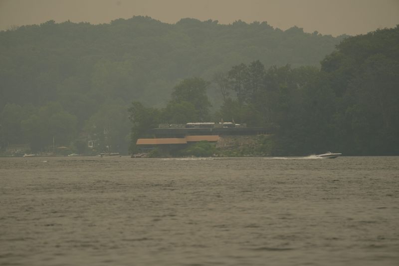 The same spot of Petra Island on Lake Mahopac on Wednesday, July 15, 2026, showing the increase in one day of the smoke from the wildfires in Canada.