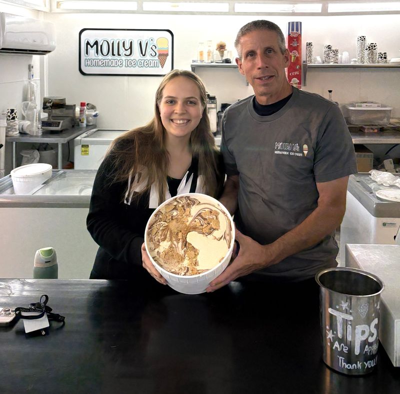 Molly V's Homemade Ice Cream owner Michael Vistocco and ice cream flavor contest winner Lily Turner show off her winning flavor: Churro Cheesecake.